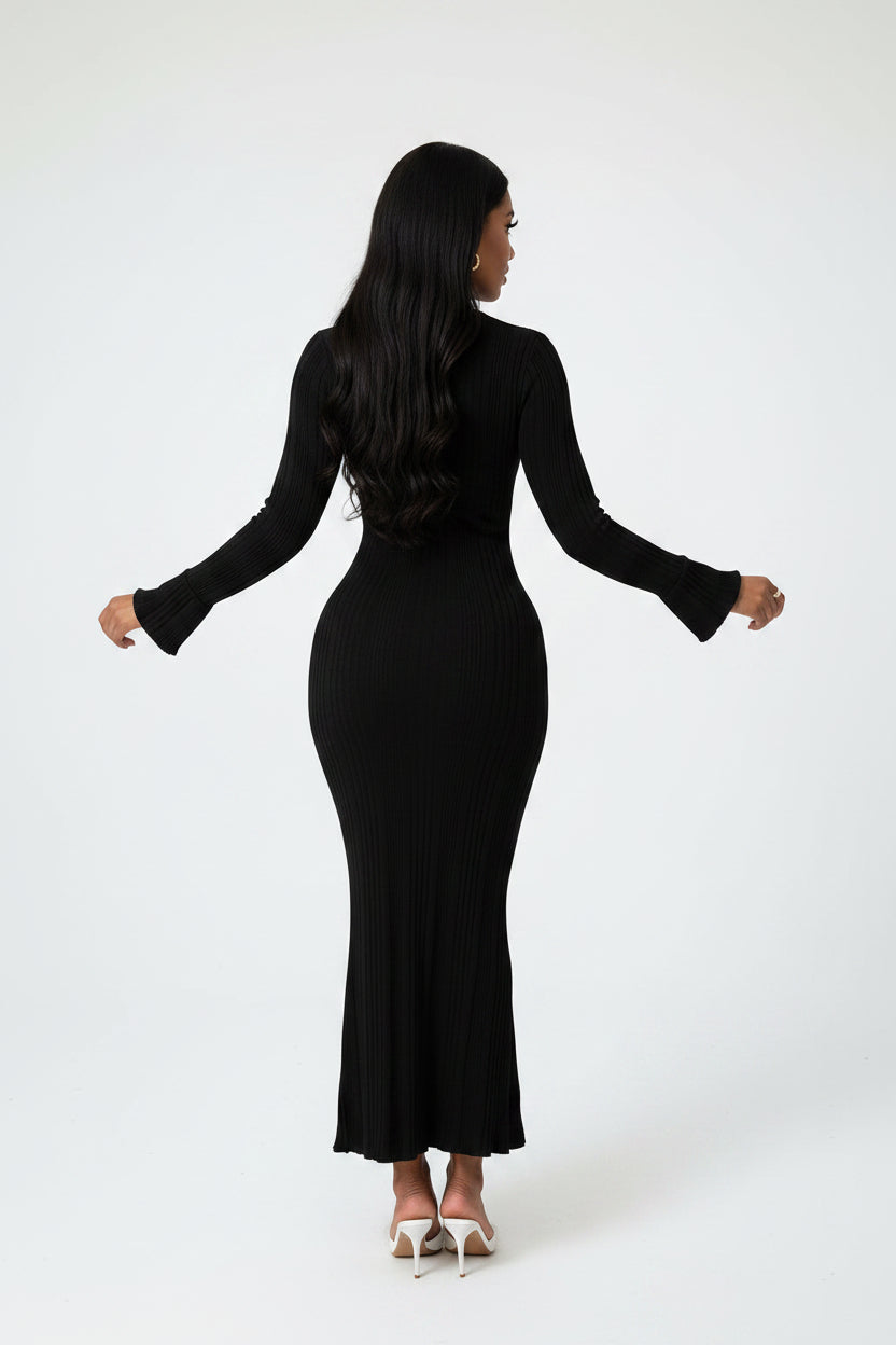 Woman wearing a black ribbed dress on a white background