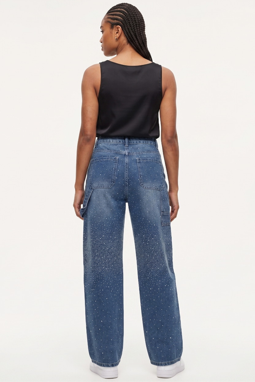 Person wearing blue jeans and a black top on a white background