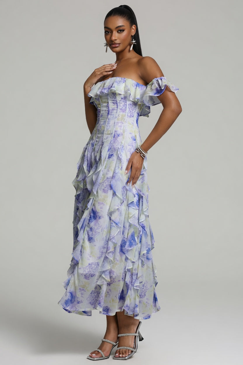 Woman wearing a floral off-shoulder dress on a plain background