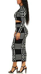 Black and white geometric patterned outfit on a model against a white background