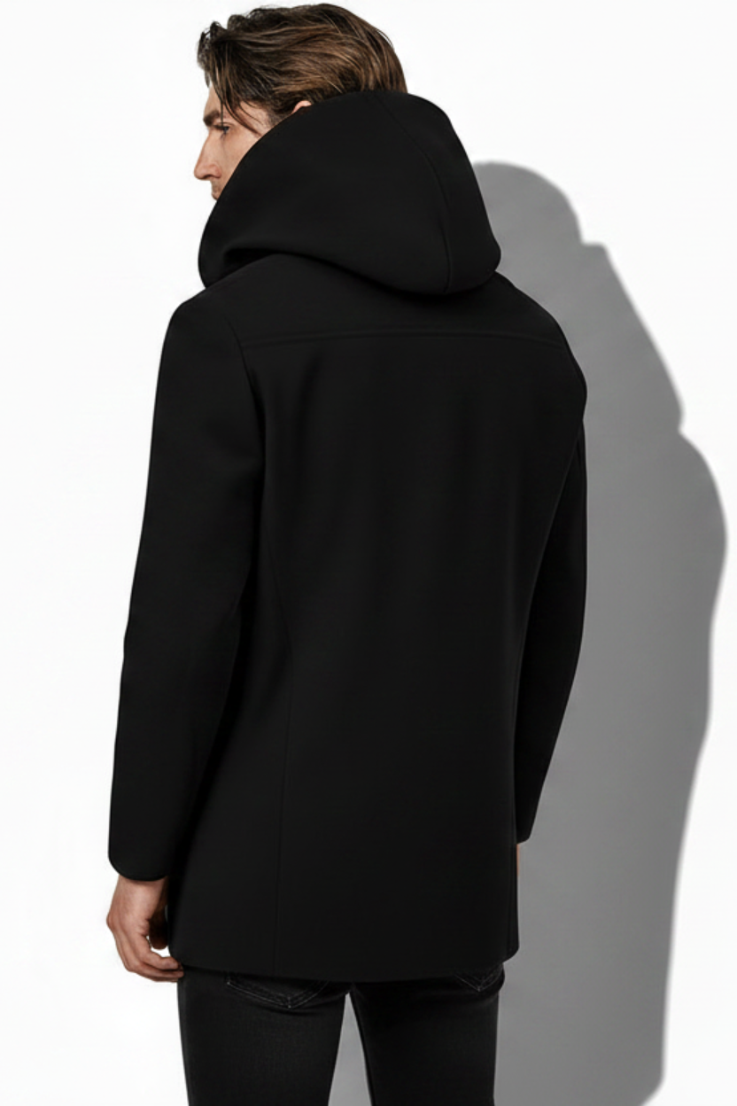 Person wearing a black coat with a hood on a white background