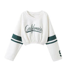 White long-sleeve crop top with 'California' text and green accents on a white background