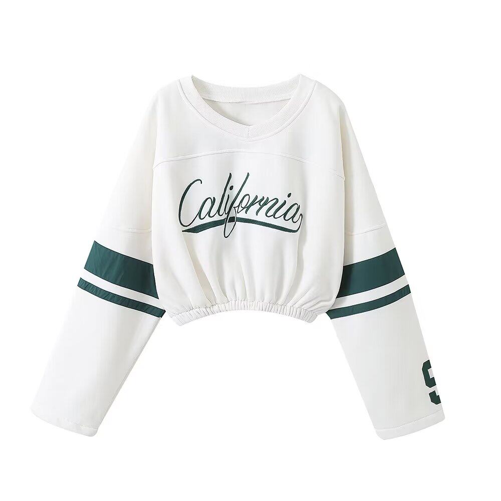 White long-sleeve crop top with 'California' text and green accents on a white background