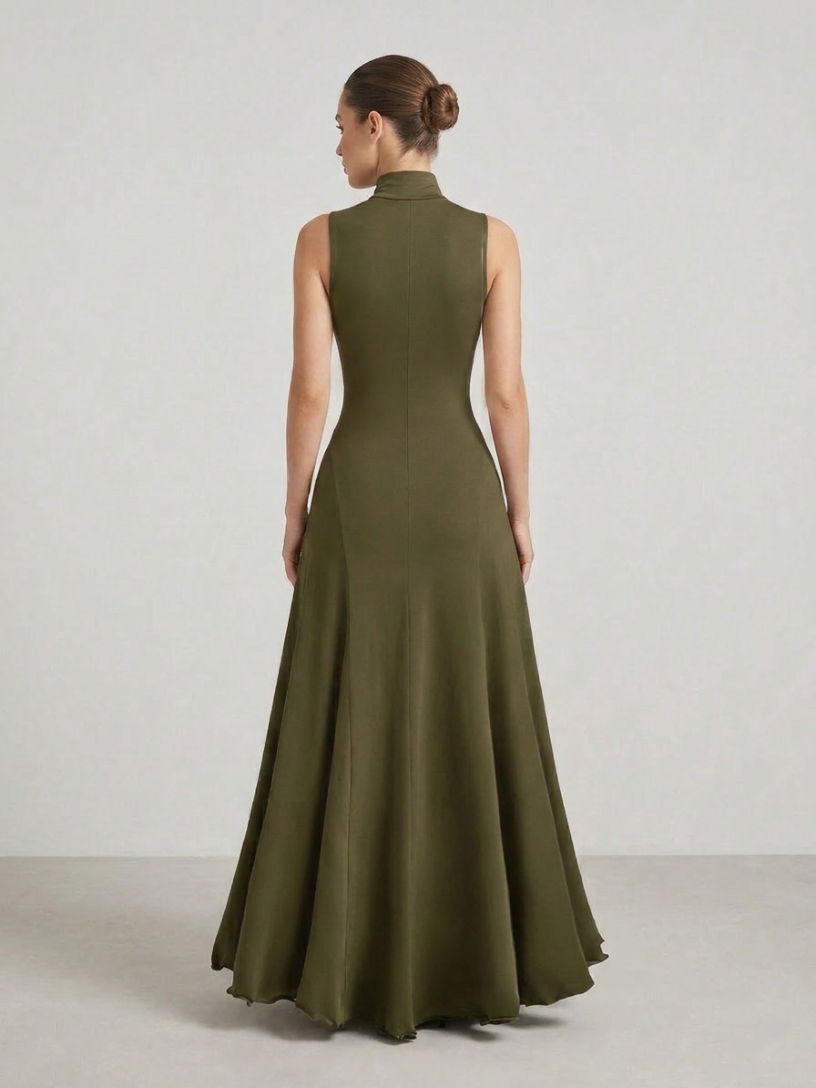 Woman wearing a green evening gown against a plain background