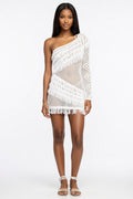 Woman wearing a white crochet one-shoulder dress on a white background