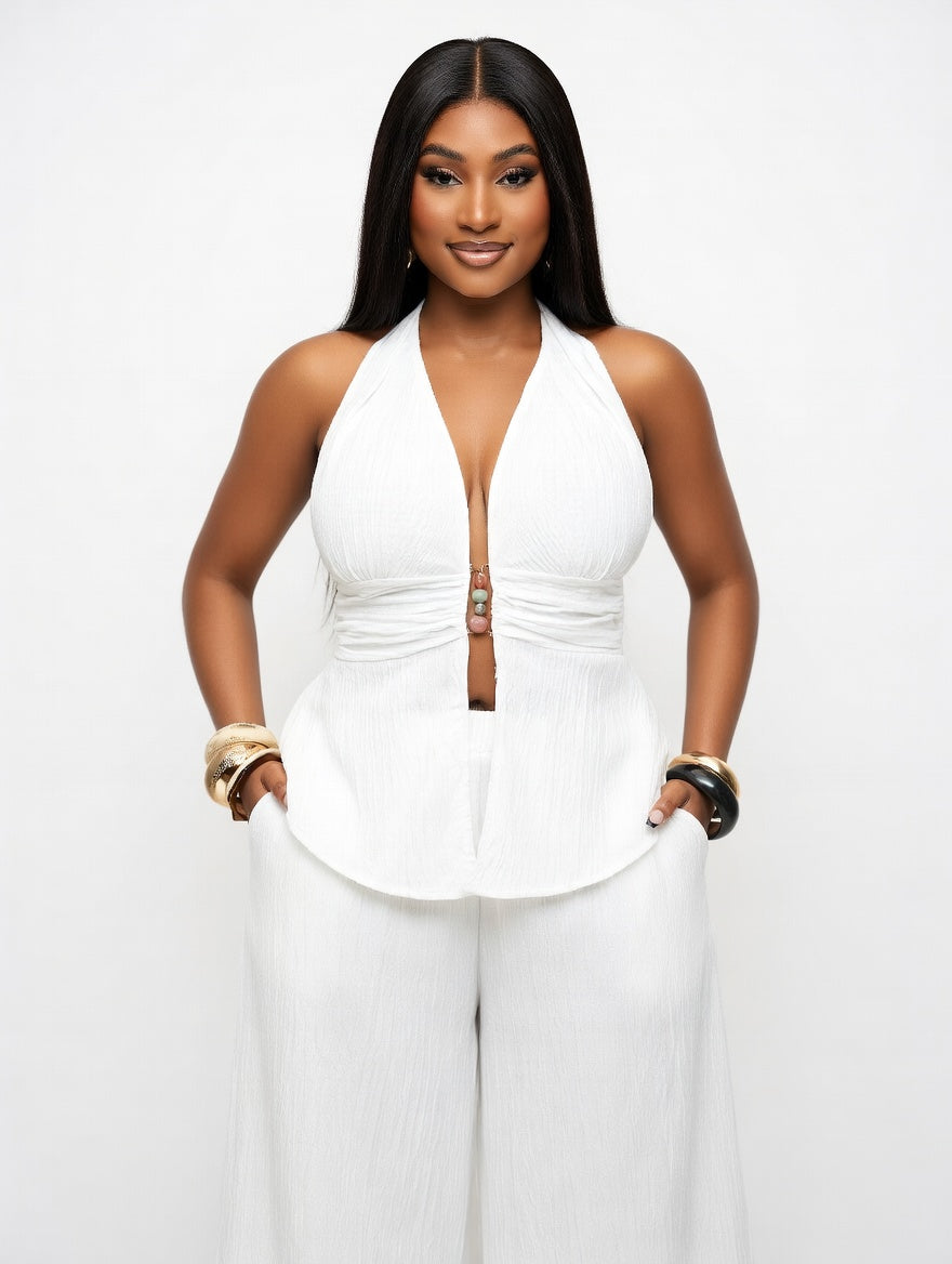 Woman wearing a white halter top and pants on a white background