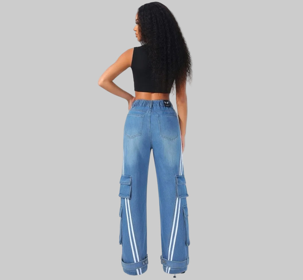Person wearing blue cargo pants with reflective stripes on a white background