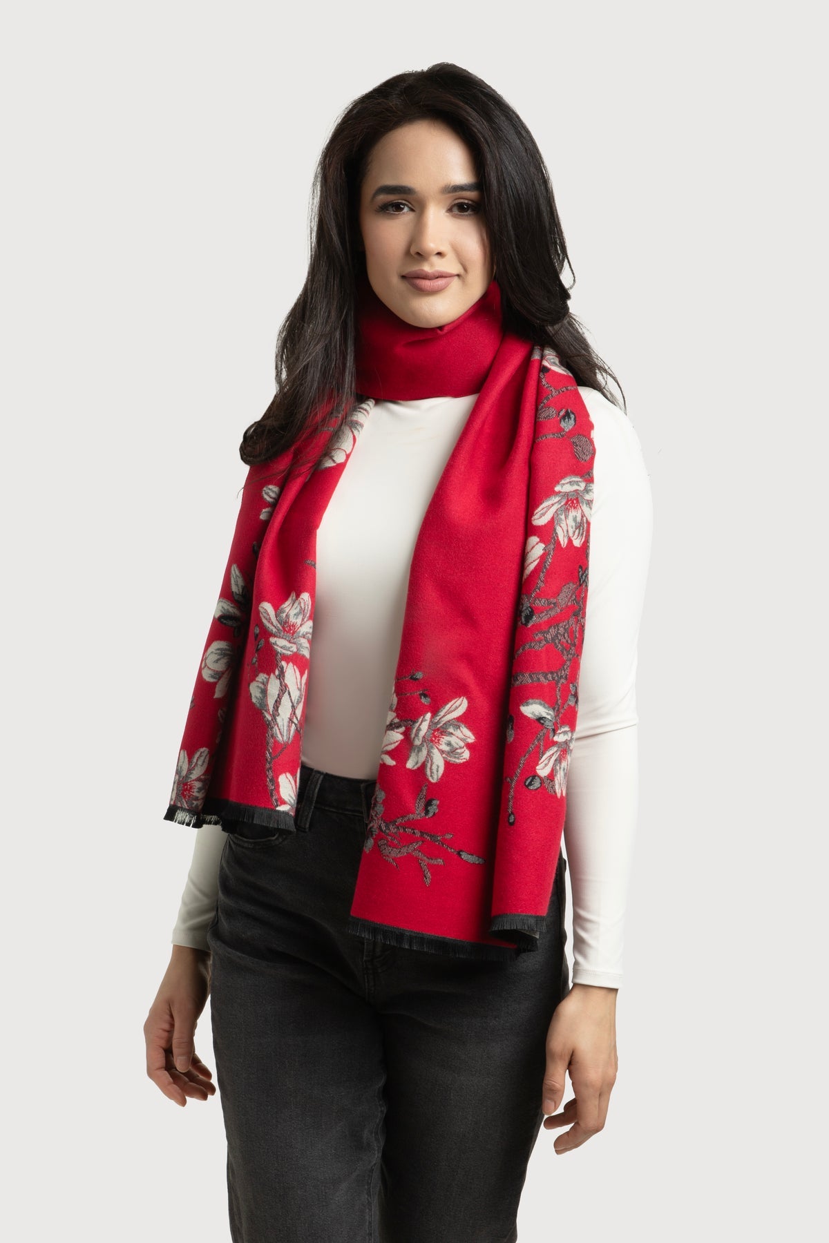 Woman wearing a red floral scarf on a white background