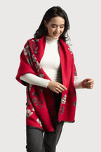 Woman wearing a red floral-patterned shawl on a white background