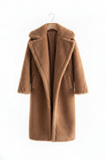Brown teddy coat on a mannequin against a gray background