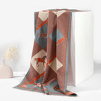 Decorative throw blanket with geometric pattern on a white surface