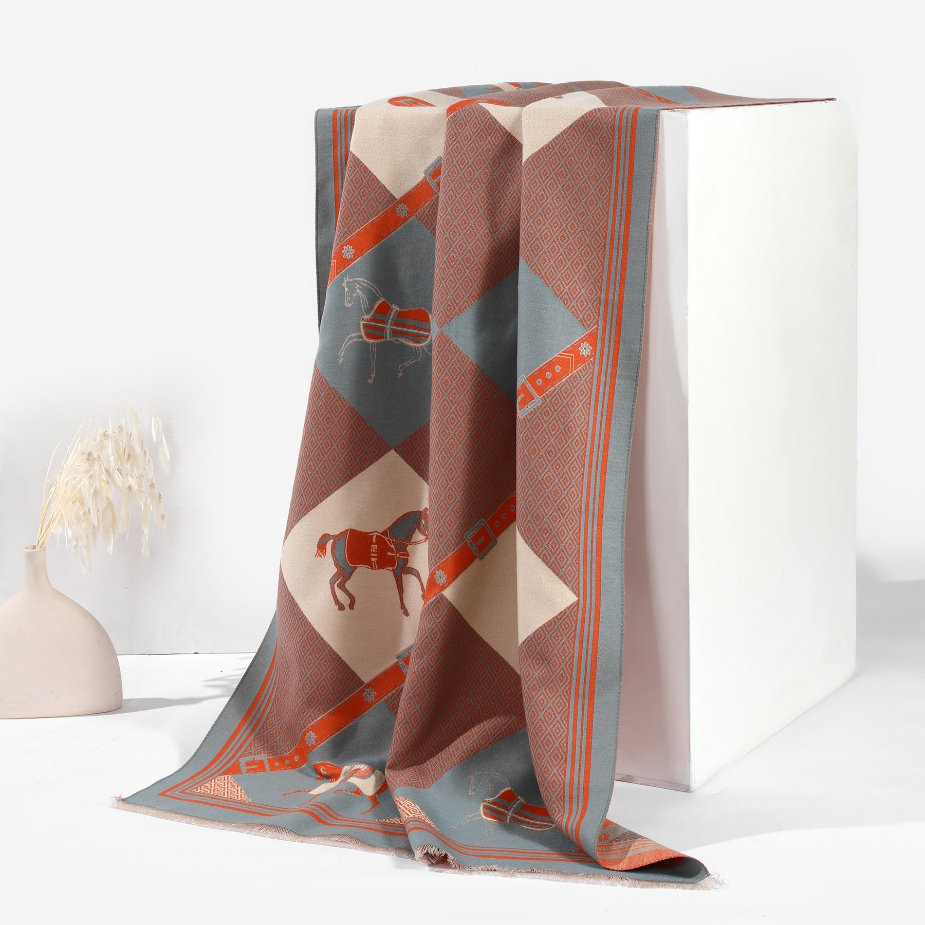 Decorative throw blanket with geometric pattern on a white surface