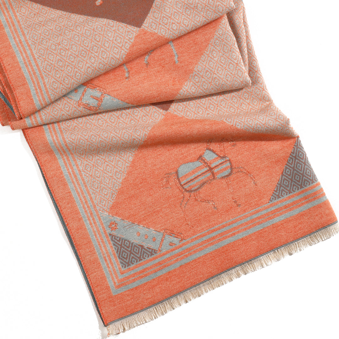 Folded fabric with geometric pattern and embroidered design on a white background