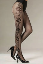 Black fishnet stockings with floral patterns worn by a person, paired with black high heels on a neutral background.  