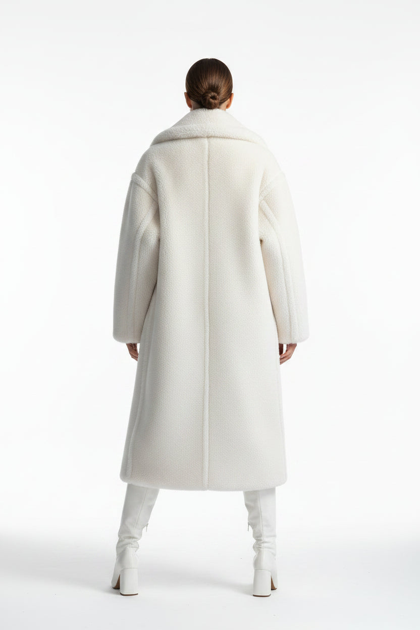 White fur coat on a mannequin against a white background