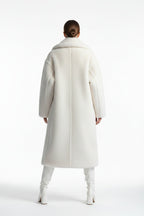 White fur coat on a mannequin against a white background