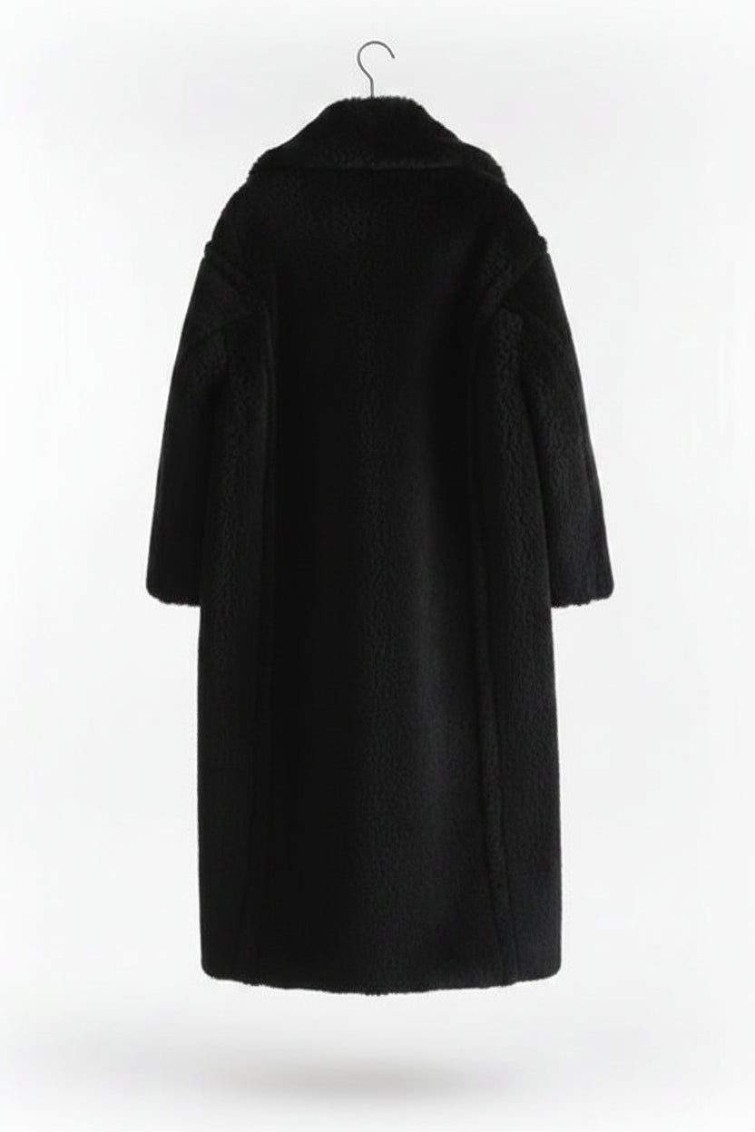 Black coat on a hanger against a white background