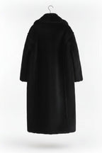 Black coat on a hanger against a white background