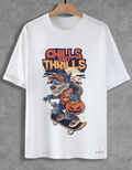 White t-shirt with a graphic design of a werewolf on a skateboard and 'Chills and Thrills' text, hanging on a wooden hanger against a gray background.