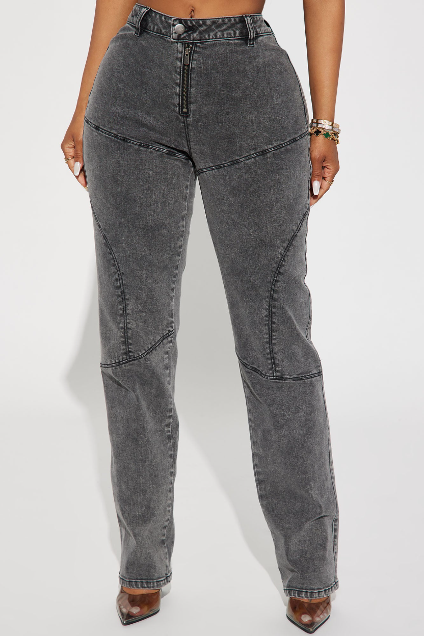Person wearing high-waisted gray jeans on a white background