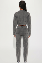 Person wearing a gray denim outfit on a white background