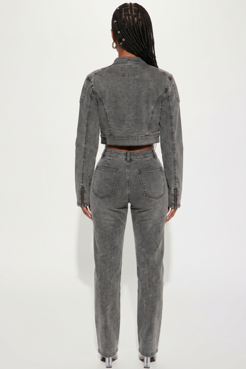 Person wearing a gray denim outfit on a white background