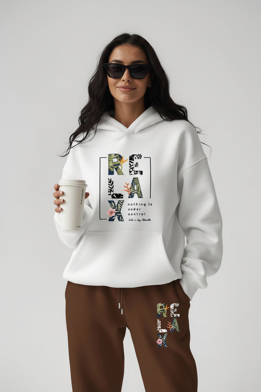 Woman wearing a white hoodie with text design, holding a coffee cup on a plain background