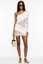 Woman wearing a white crochet cover-up on a white background