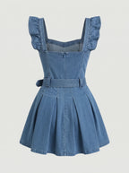 Model wearing a short-sleeved denim mini dress is crafted from a medium-blue wash denim featuring a structured, square-necked bodice with molded, bustier-style seaming and playful ruffled shoulder straps. Designed with a fitted waist cinched by a matching fabric belt with a metallic buckle, the dress flows down into a flared, pleated skater skirt that creates a crisp, youthful silhouette.