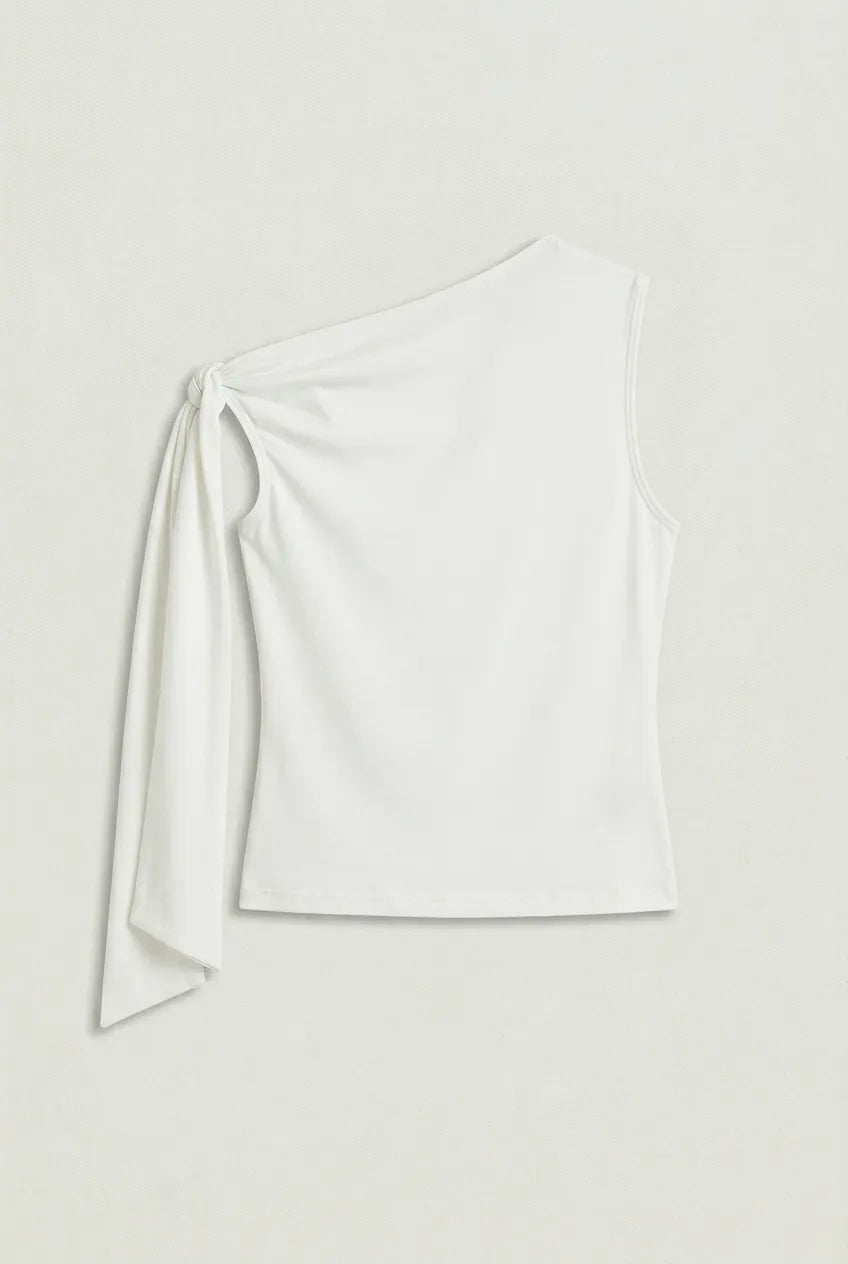 a white asymmetric one-shoulder sleeveless top with subtle neck gathering and a draped tie detail on the left shoulder