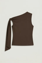 a dark brown asymmetric one-shoulder sleeveless top with subtle neck gathering and a draped tie detail on the left shoulder