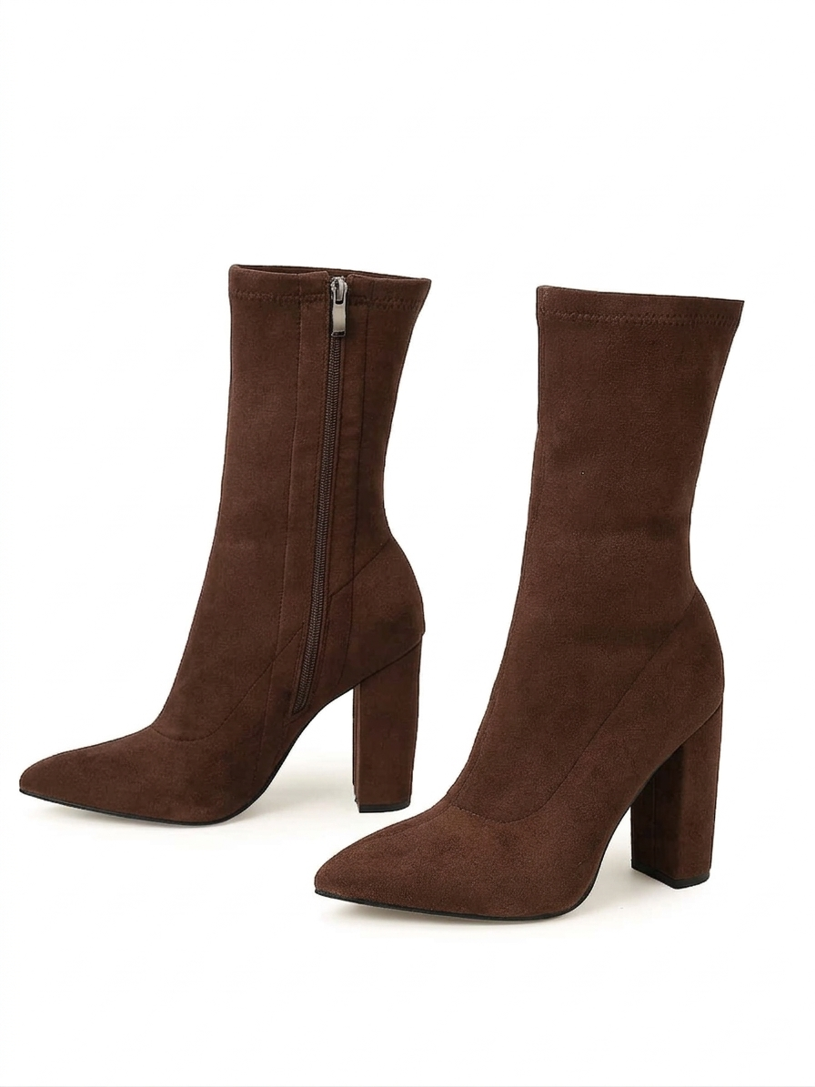 Pair of brown suede ankle boots on a white background