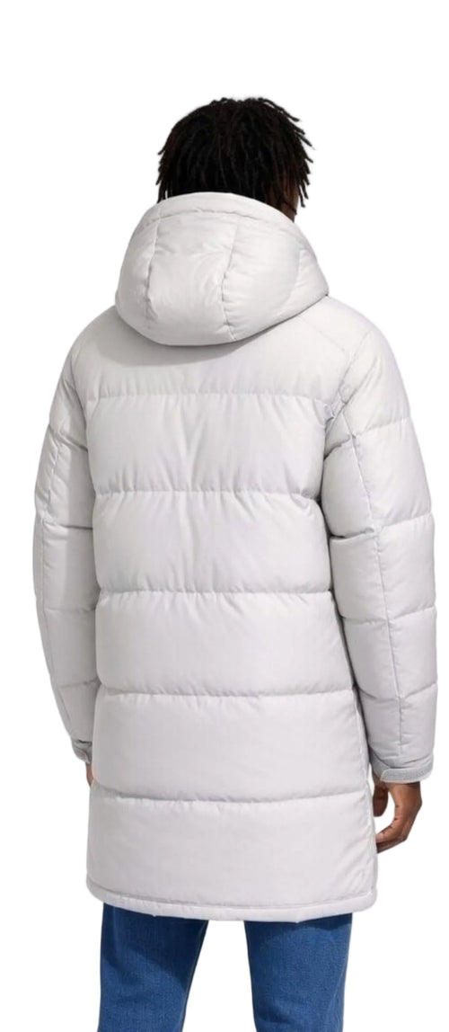 Person wearing a long white puffer coat on a white background
