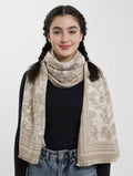 Woman wearing a beige patterned scarf on a white background