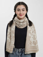 Woman wearing a beige patterned scarf on a white background