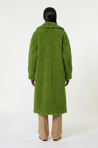Person wearing a green coat on a white background