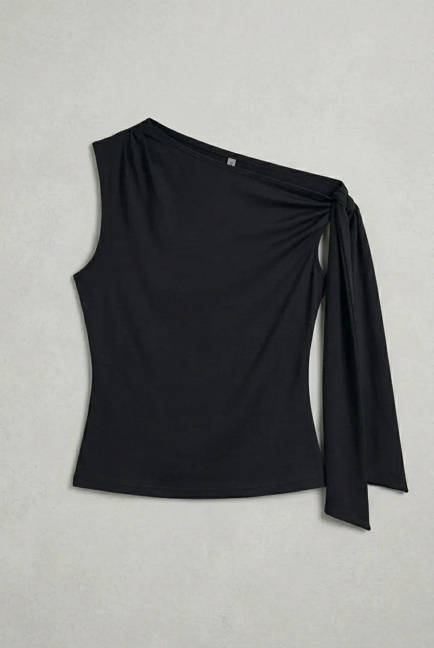 a black asymmetric one-shoulder sleeveless top with subtle neck gathering and a draped tie detail on the left shoulder