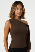 a dark brown asymmetric one-shoulder sleeveless top with subtle neck gathering and a draped tie detail on the left shoulder