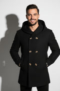 Black coat with gold buttons worn by a person on a white background