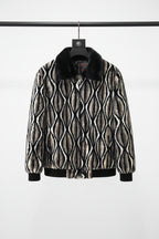 Patterned jacket with fur collar on a hanger against a neutral background