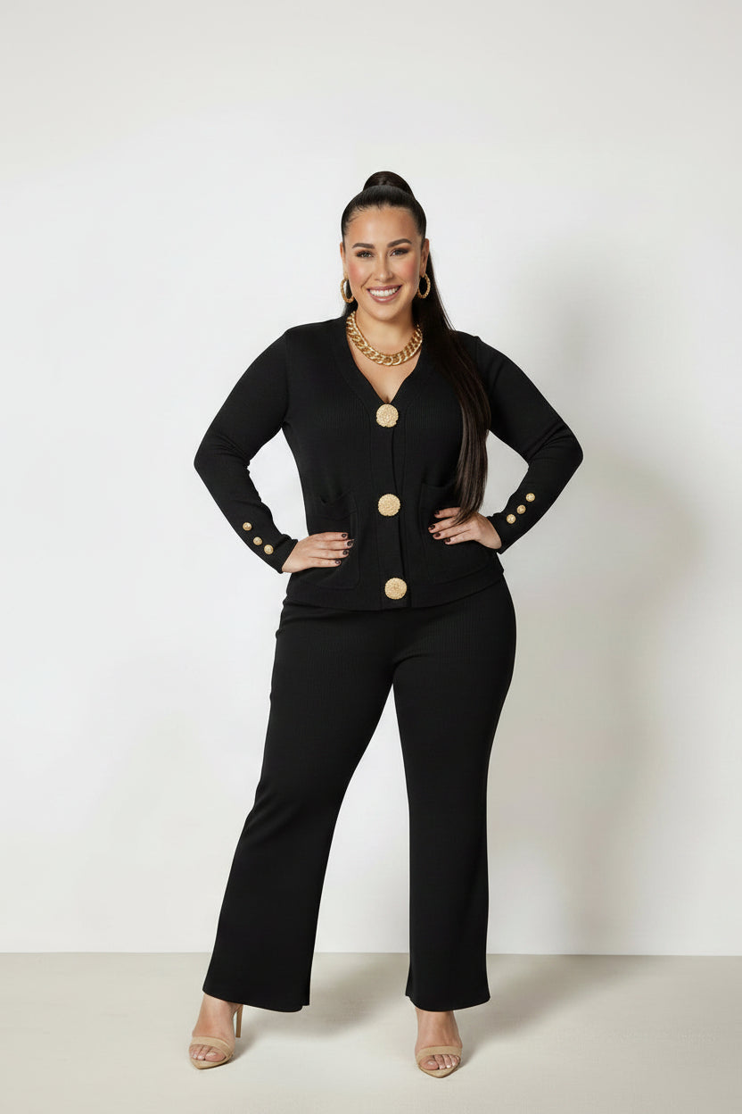 Woman wearing a black outfit with gold buttons on a white background