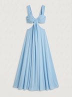 The dress shown is a crimson blue maxi dress featuring side cutouts at the waist, a structured sweetheart bustier top with gathered drape detail, wide shoulder straps, and a bow tie backclosure.
