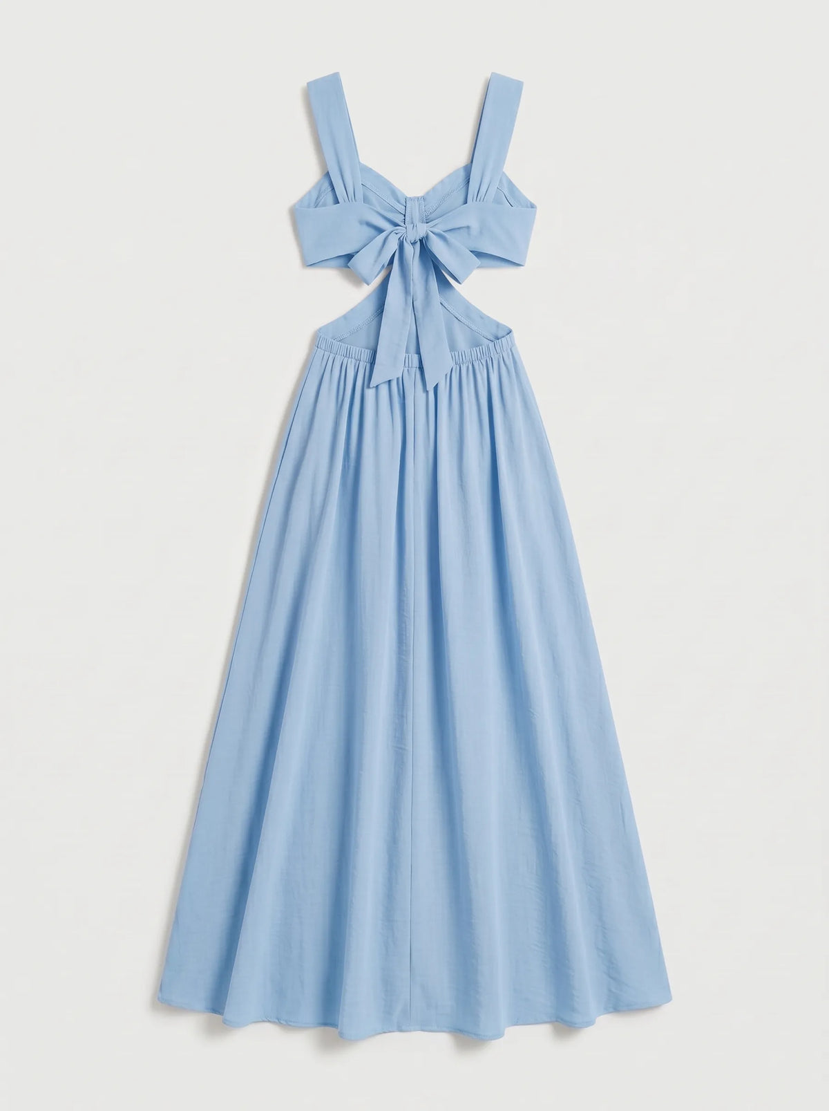 The dress shown is a crimson blue maxi dress featuring side cutouts at the waist, a structured sweetheart bustier top with gathered drape detail, wide shoulder straps, and a bow tie backclosure.