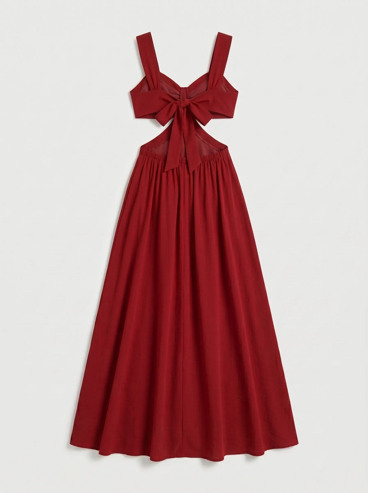 The dress shown is a crimson red maxi dress featuring side cutouts at the waist, a structured sweetheart bustier top with gathered drape detail, wide shoulder straps, and a bow tie backclosure.