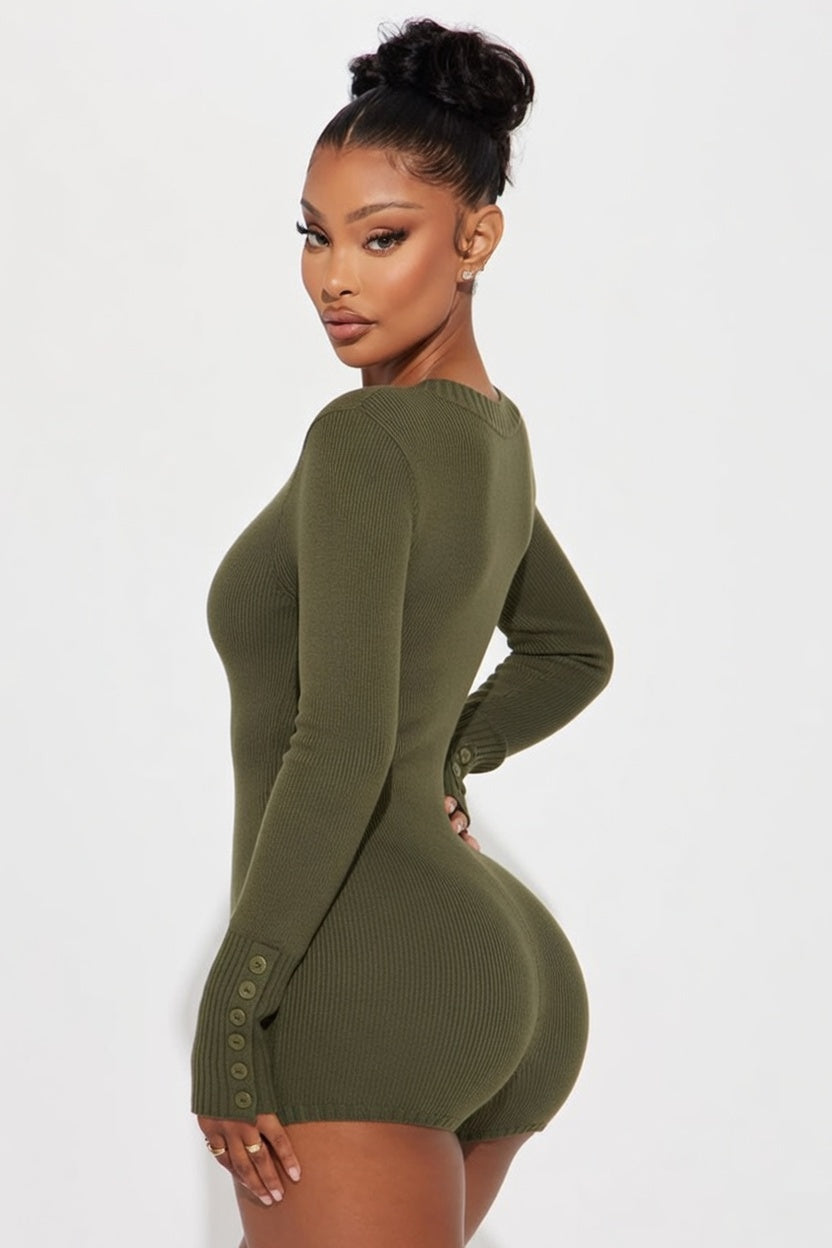 Woman wearing a green ribbed dress against a white background