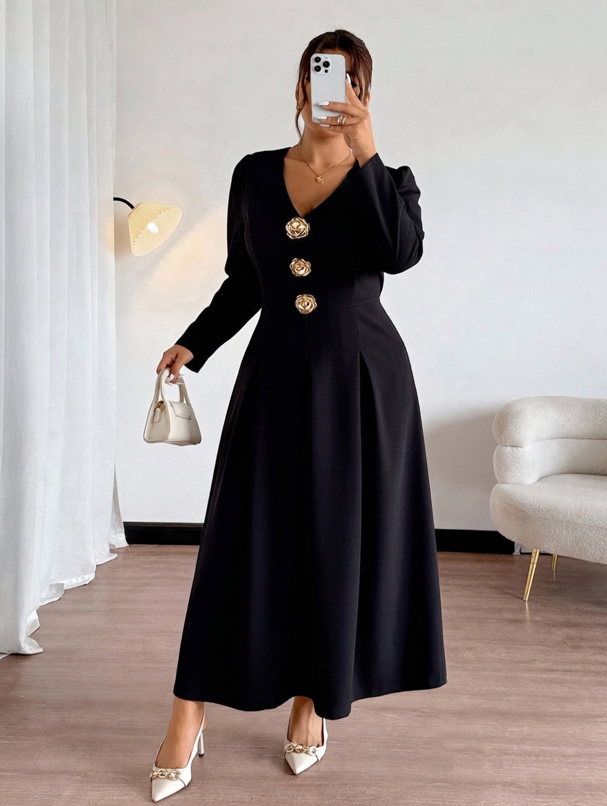 Woman wearing a black dress with gold buttons in a room.