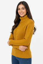 Woman wearing a mustard yellow cable knit turtleneck sweater on a white background
