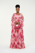 Woman wearing a pink floral dress on a white background