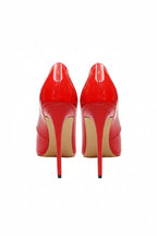 Pair of red high-heeled shoes on a white background