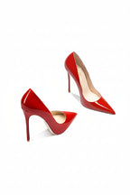 Red high-heeled shoes on a white background